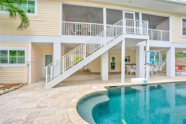 a view of staircase with wooden floor and white walls