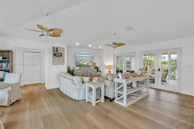 a living room with furniture kitchen view and a large window