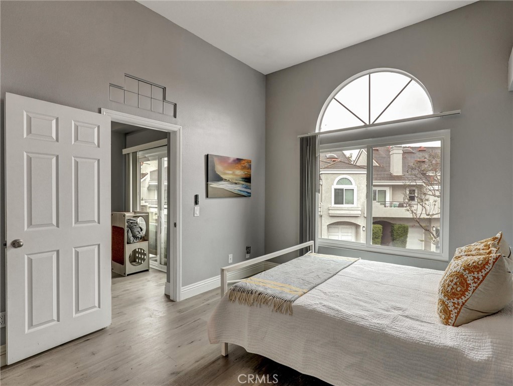 25081 Leucadia Street, Unit F Laguna Niguel, CA 92677 - Photo 13 of 30 a bedroom with a bed and a large window