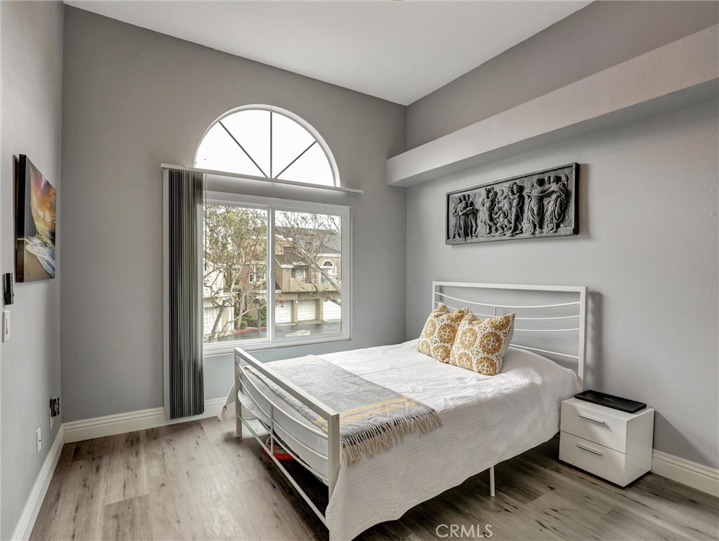 25081 Leucadia Street, Unit F Laguna Niguel, CA 92677 - Photo 14 of 30 a bedroom with a bed and a window