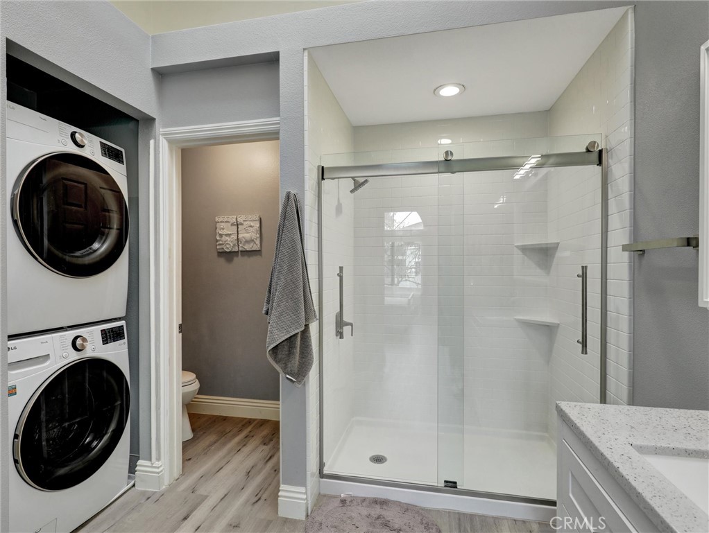 25081 Leucadia Street, Unit F Laguna Niguel, CA 92677 - Photo 17 of 30 a bathroom with a granite countertop shower a mirror and a shower