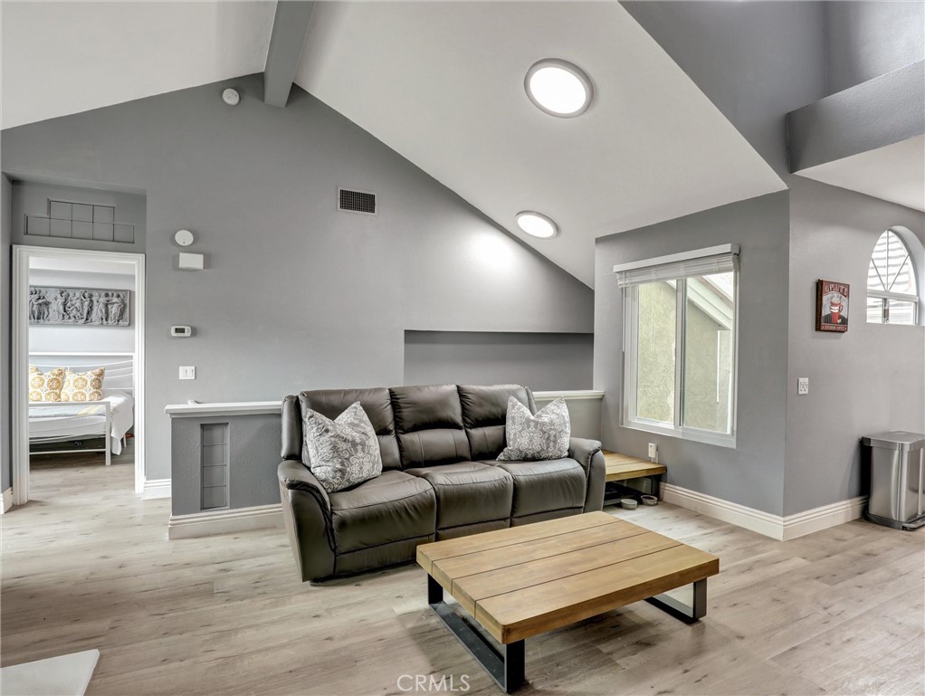 25081 Leucadia Street, Unit F Laguna Niguel, CA 92677 - Photo 2 of 30 a living room with furniture and a wooden floor