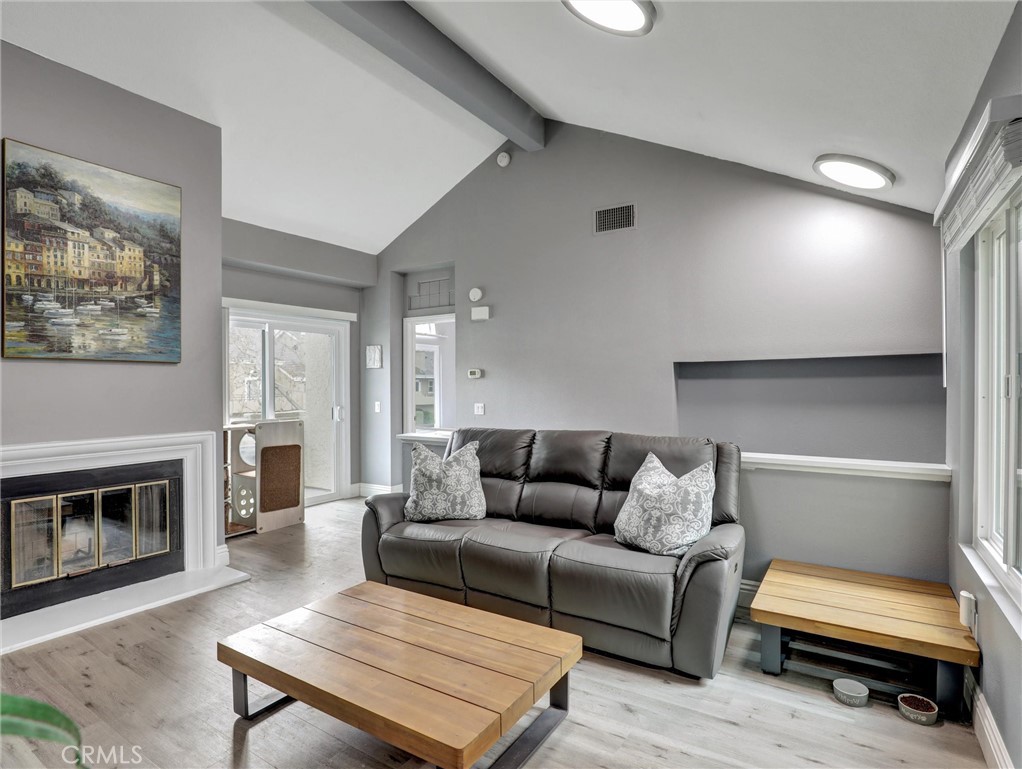 25081 Leucadia Street, Unit F Laguna Niguel, CA 92677 - Photo 4 of 30 a living room with furniture and a fireplace
