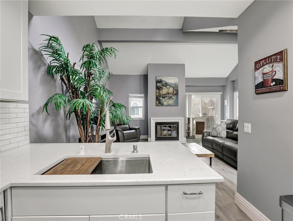 25081 Leucadia Street, Unit F Laguna Niguel, CA 92677 - Photo 8 of 30 a kitchen with a refrigerator and a more windows