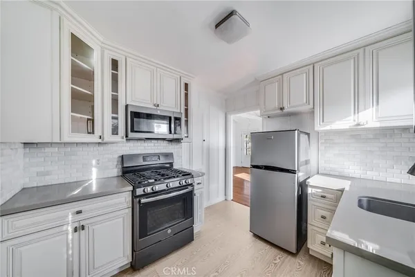 a kitchen with cabinets and steel stainless steel appliances