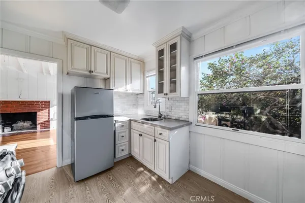 a kitchen with a sink a refrigerator and window