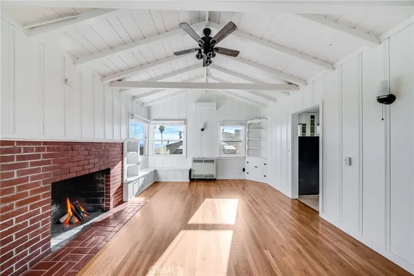 wooden floor in an empty room with a fireplace