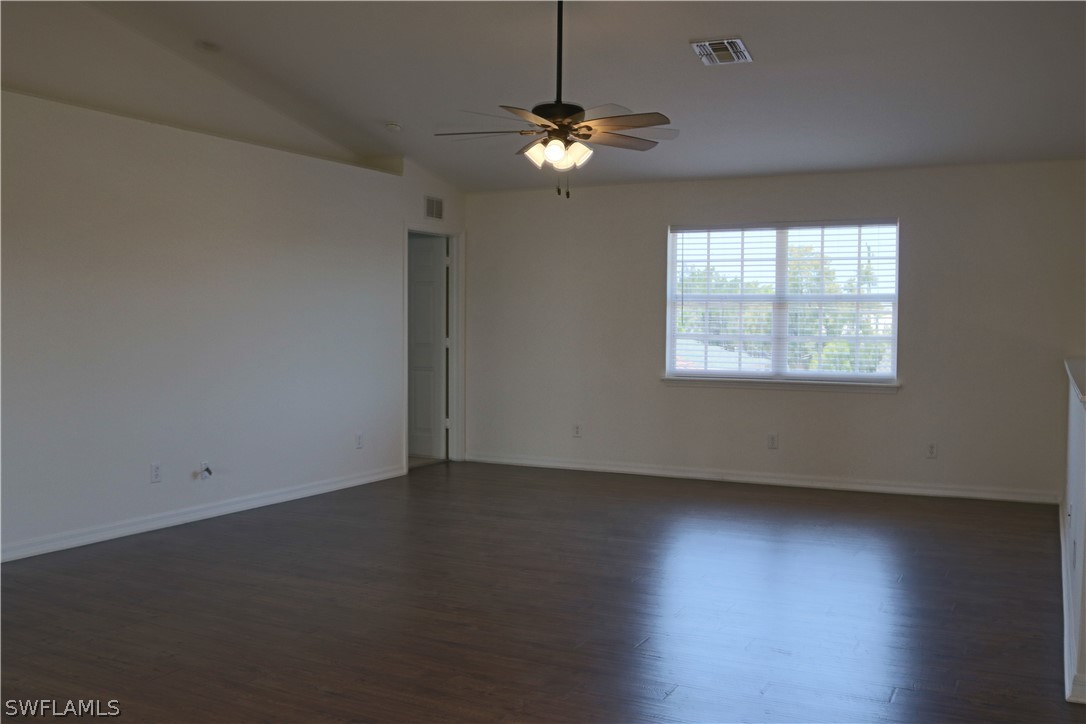 18425 Iris Road Fort Myers, FL 33967 - Photo 11 of 27 an empty room with wooden floor and windows