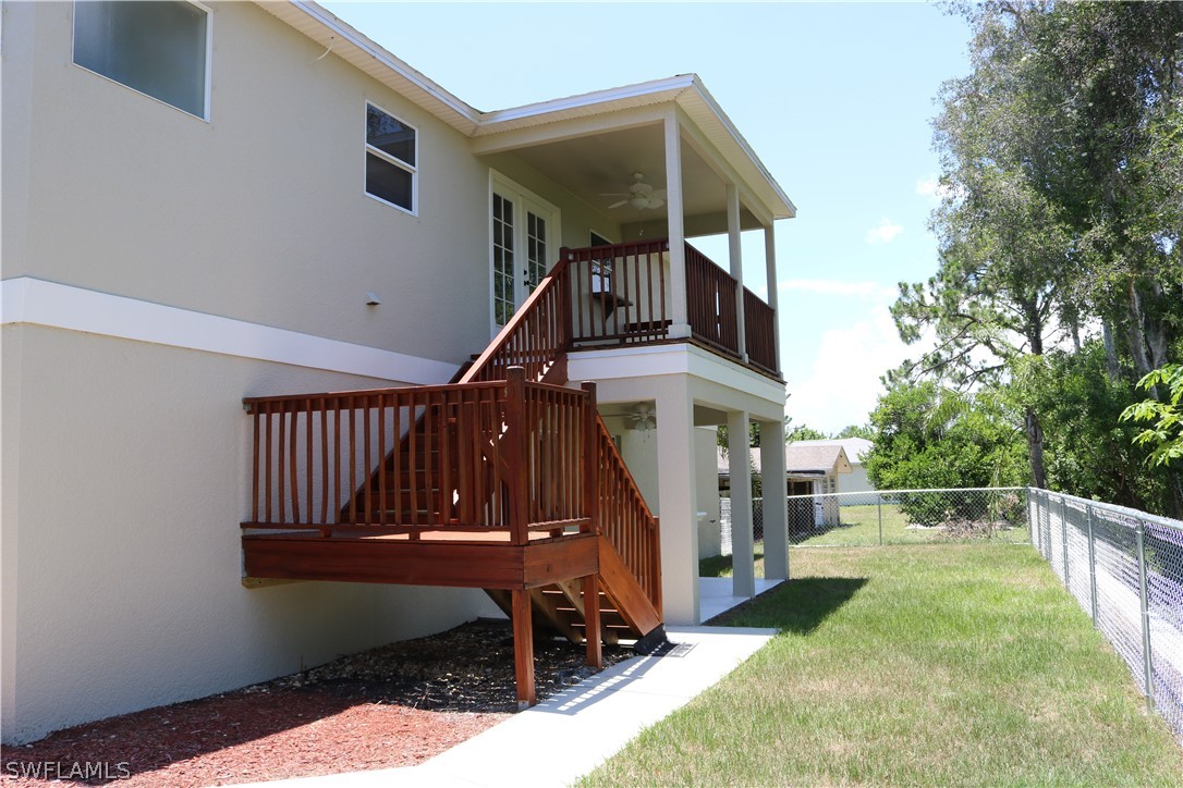18425 Iris Road Fort Myers, FL 33967 - Photo 25 of 27 a view of house with a swimming pool and wooden deck