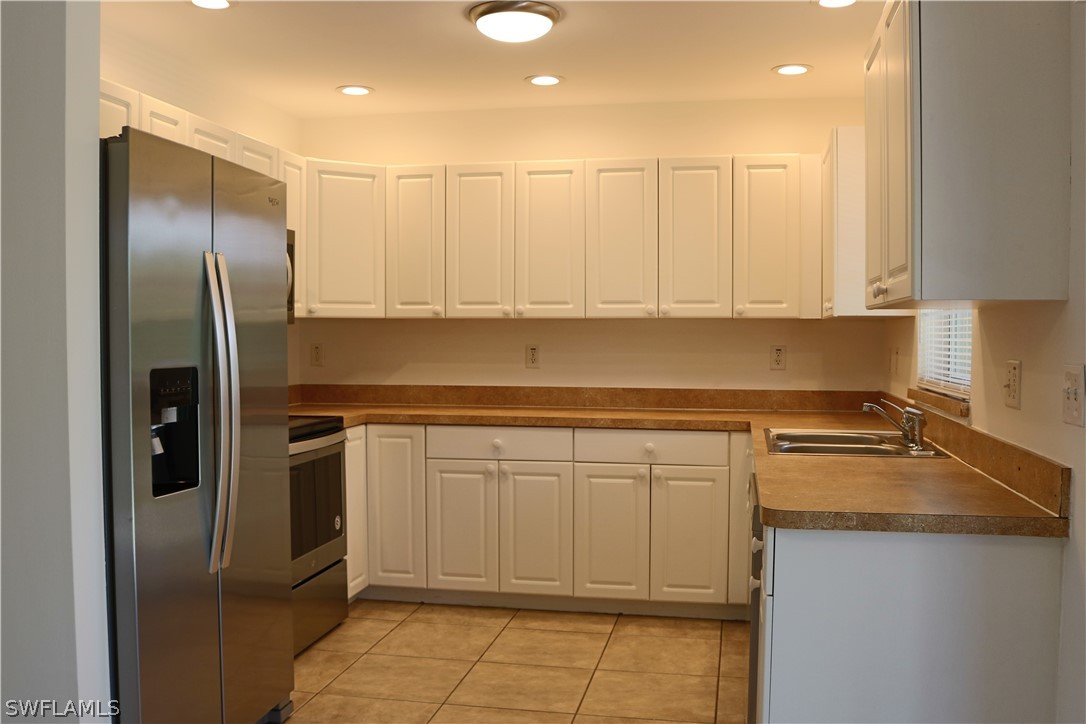 18425 Iris Road Fort Myers, FL 33967 - Photo 27 of 27 a kitchen with stainless steel appliances granite countertop a refrigerator a sink and white cabinets