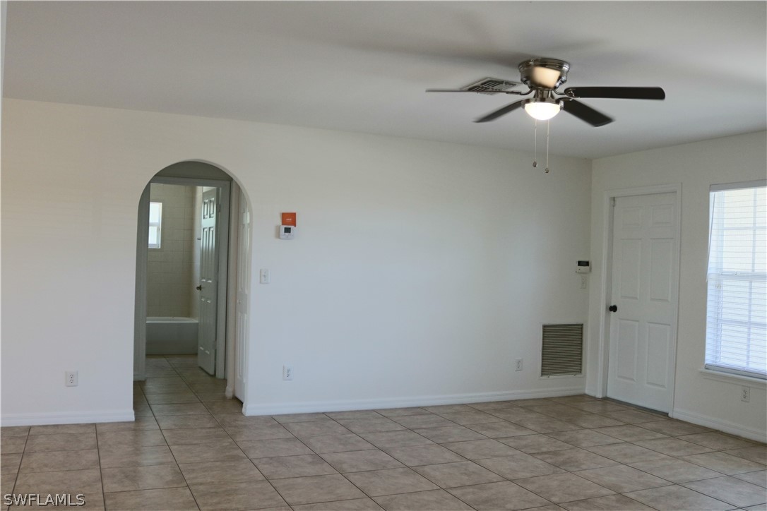 18425 Iris Road Fort Myers, FL 33967 - Photo 3 of 27 wooden floor in an empty room with a window