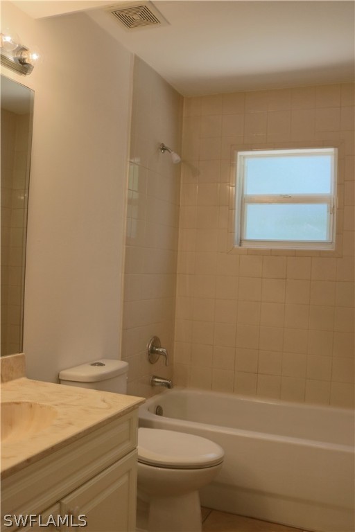 18425 Iris Road Fort Myers, FL 33967 - Photo 7 of 27 a bathroom with a granite countertop toilet a sink and a bathtub