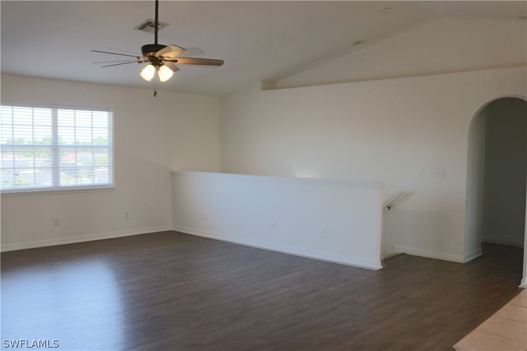 18425 Iris Road Fort Myers, FL 33967 - Photo 10 of 27 an empty room with wooden floor chandelier and windows