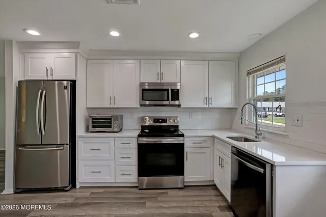 a kitchen with a refrigerator stove and microwave