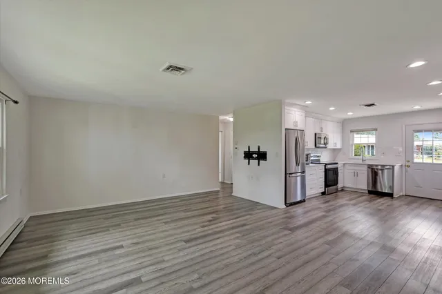 a view of a kitchen with wooden floor