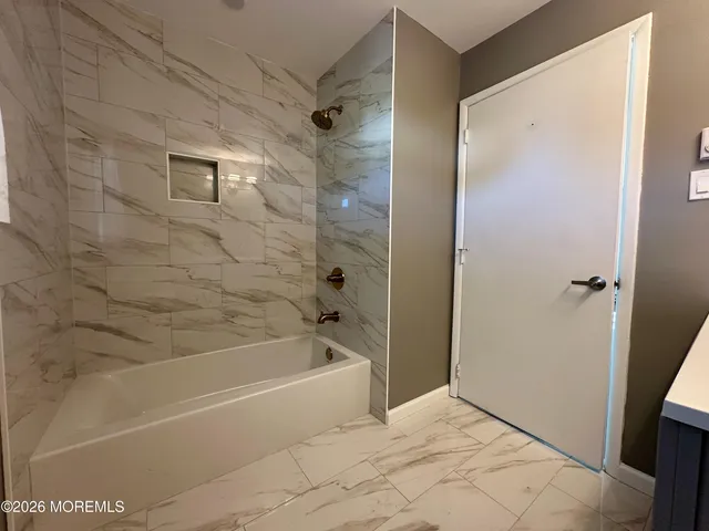 a bathroom with a bathtub and a shower
