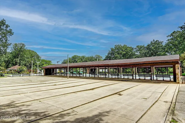 a view of a lake with a building and trees in the background