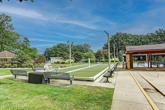 a view of a house with a big yard and potted plants