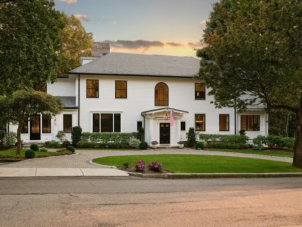 a front view of a house with a garden and plants