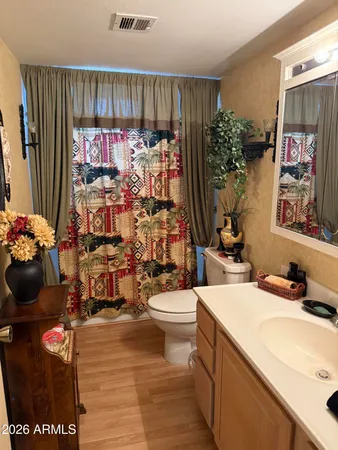 a bathroom with a sink mirror and toilet