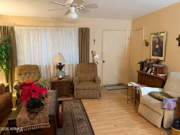 a living room with furniture and a chandelier