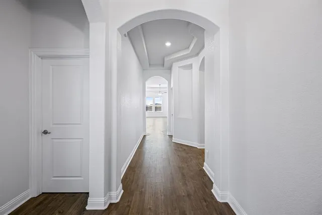 a view of a hallway with wooden floor