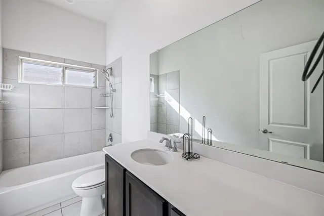 a bathroom with a sink toilet tub and shower