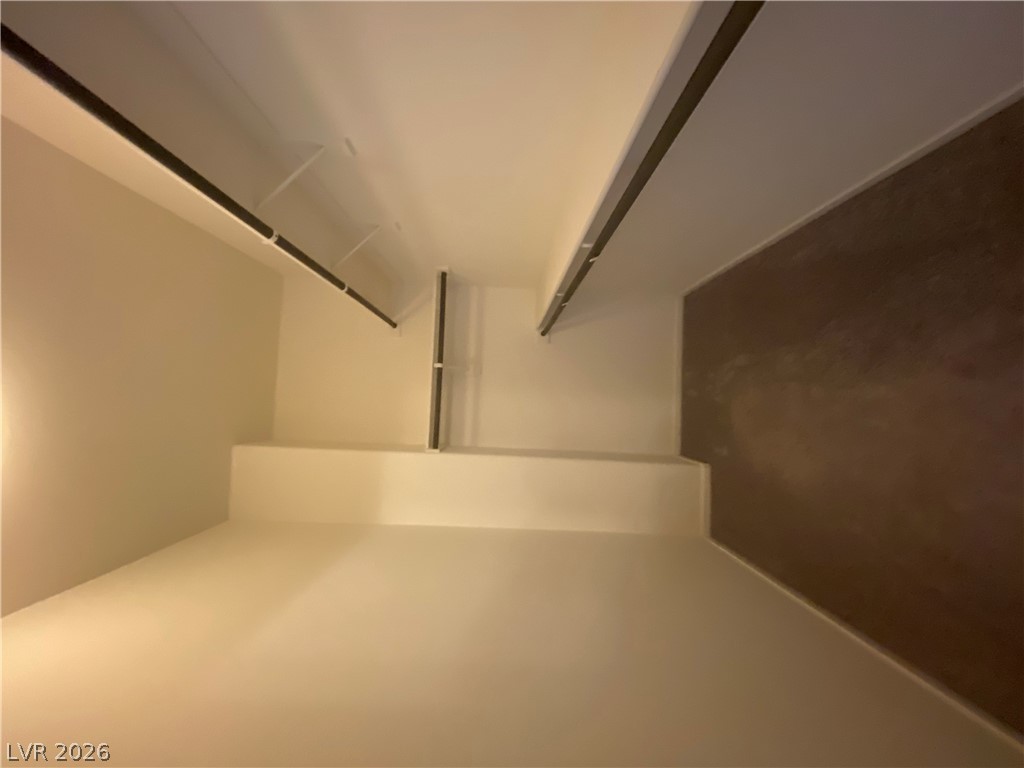 436 Cadence View Way Henderson, NV 89011 - Photo 24 of 36 Integrated shelving and hanging rods define this organized closet space.