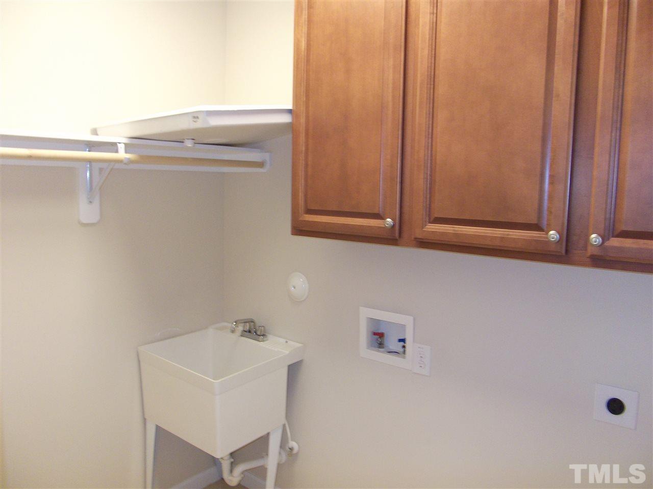 2993 Rolling Hill Road Durham, NC 27705 - Photo 16 of 25 Just off Kitchen for convenience is the utility room with "wash basin". Custom Cabinets!