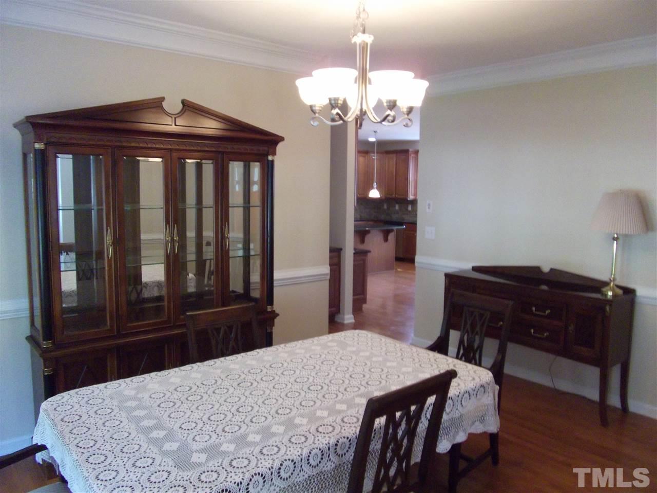 2993 Rolling Hill Road Durham, NC 27705 - Photo 7 of 25 Formal Dining Room with 2 piece chair and crown molding.