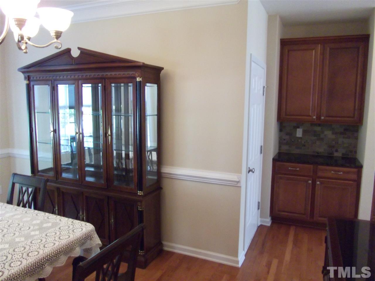 2993 Rolling Hill Road Durham, NC 27705 - Photo 8 of 25 Dining room offers adjacent "Butler's Pantry" with Granite counter and custom shelving.