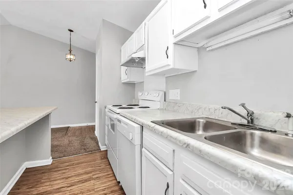 a kitchen with stainless steel appliances granite countertop a sink and a stove