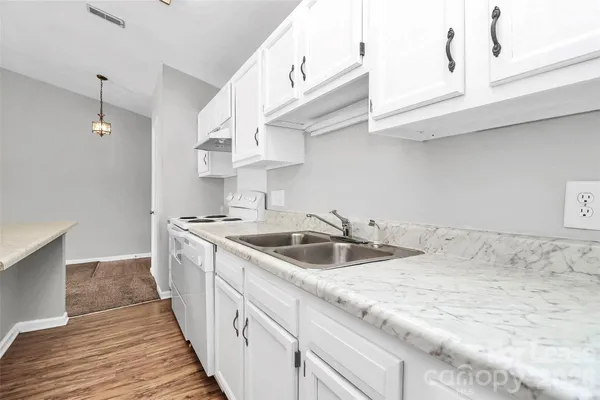 a kitchen with stainless steel appliances granite countertop a sink and dishwasher