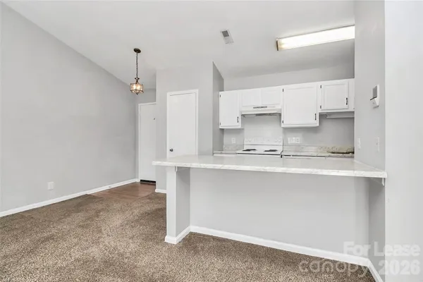 a kitchen with kitchen island a sink stainless steel appliances and cabinets