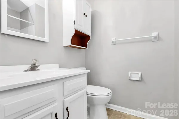 a bathroom with a sink a toilet and mirror
