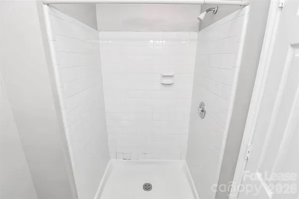 a bathroom with a glass shower door