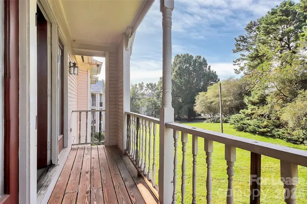 a view of a balcony with wooden floor