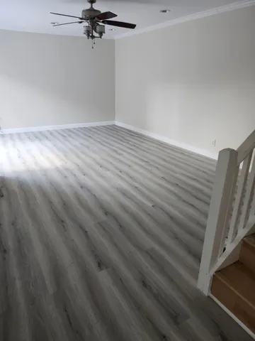a view of a room with wooden floor