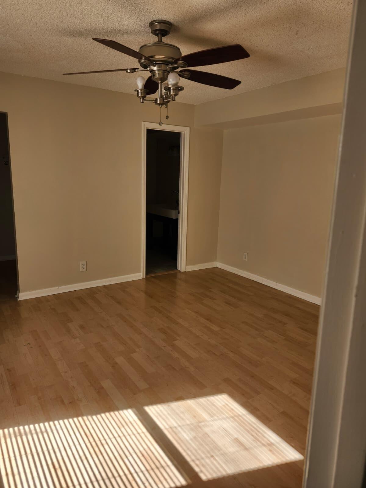 7519 Courtyard Run East Boca Raton, FL 33433 - Photo 15 of 29 a view of a hallway with wooden floor and chandelier