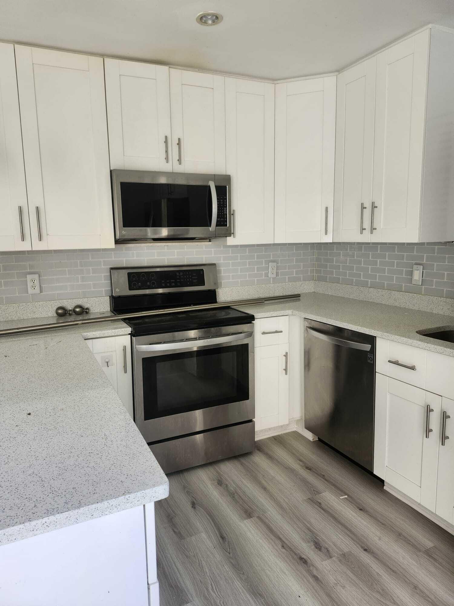 7519 Courtyard Run East Boca Raton, FL 33433 - Photo 5 of 29 a kitchen with cabinets appliances and a sink