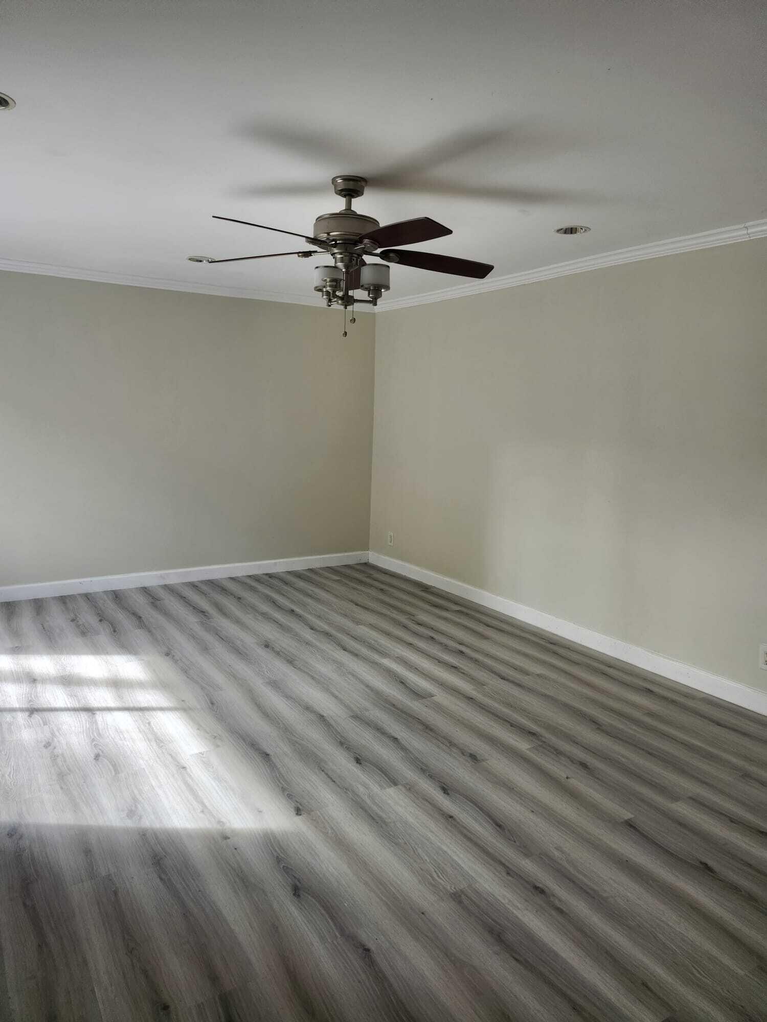 7519 Courtyard Run East Boca Raton, FL 33433 - Photo 9 of 29 a view of a room with wooden floor and fan