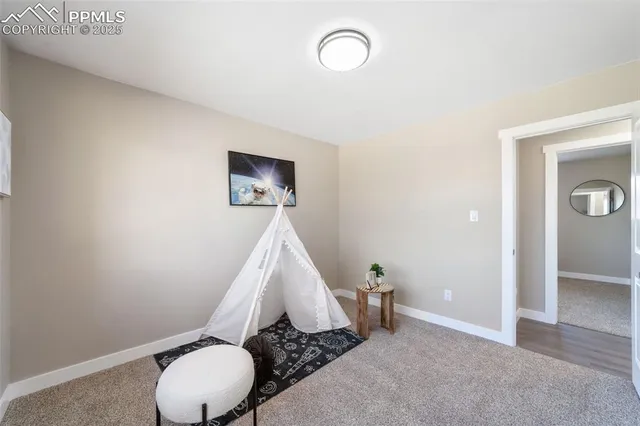 a bathroom with a toilet and a mirror