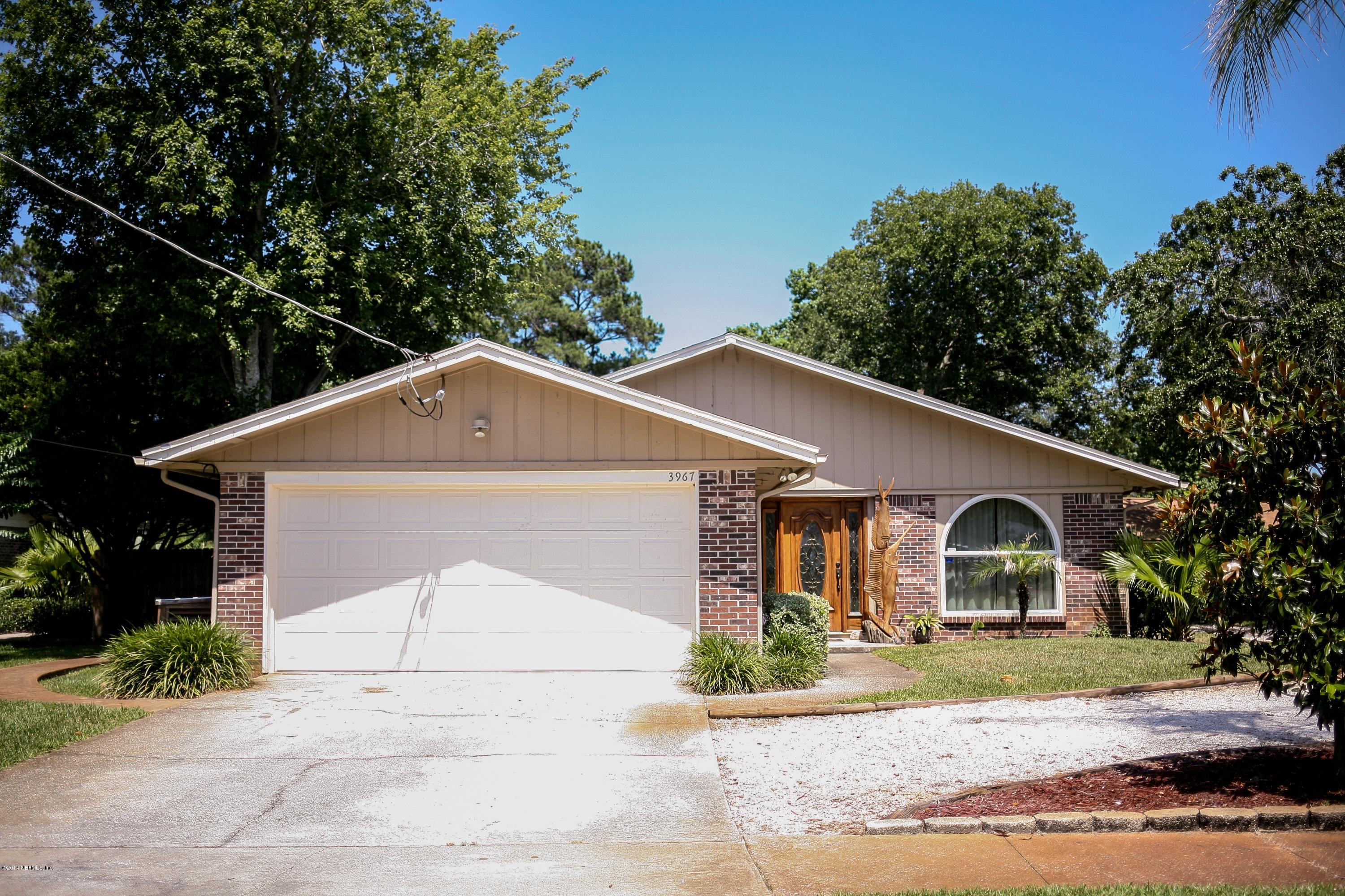 3967 Eunice Road Jacksonville, FL 32250 - Photo 1 of 28 a view of a white house with a yard and large tree