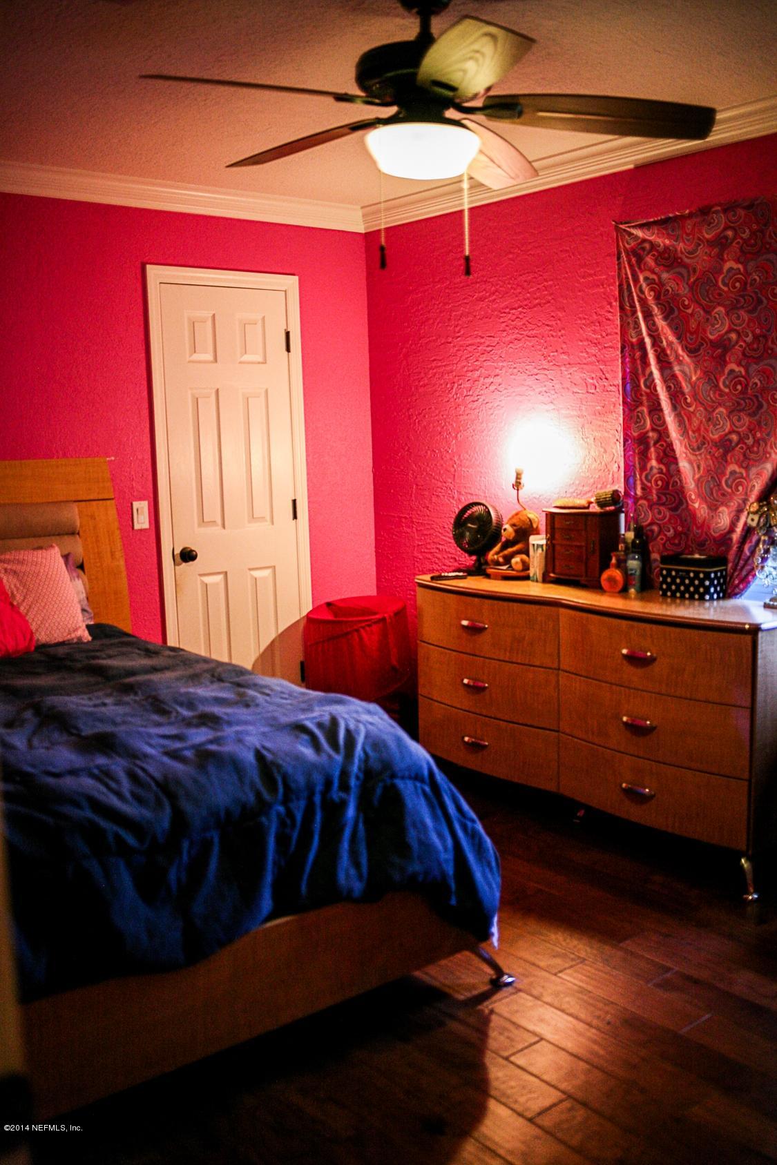 3967 Eunice Road Jacksonville, FL 32250 - Photo 11 of 28 a bedroom with a bed and a closet