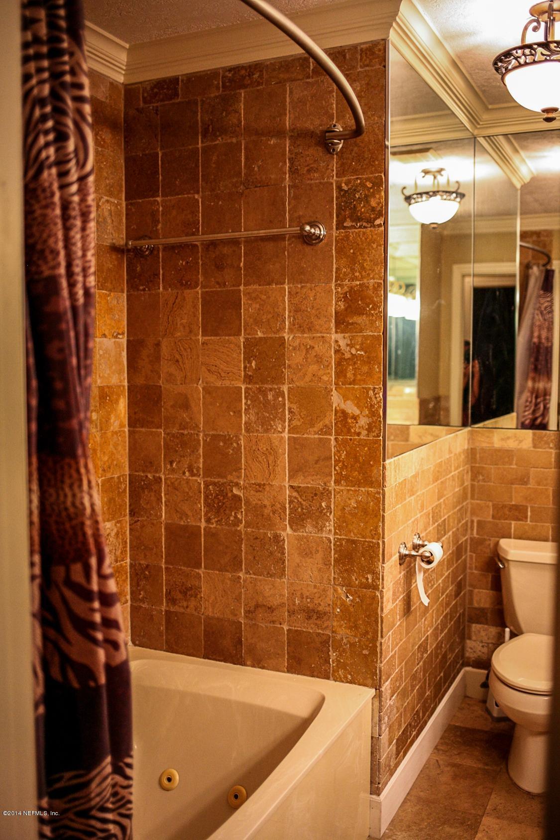 3967 Eunice Road Jacksonville, FL 32250 - Photo 13 of 28 a bathroom with a shower and a toilet