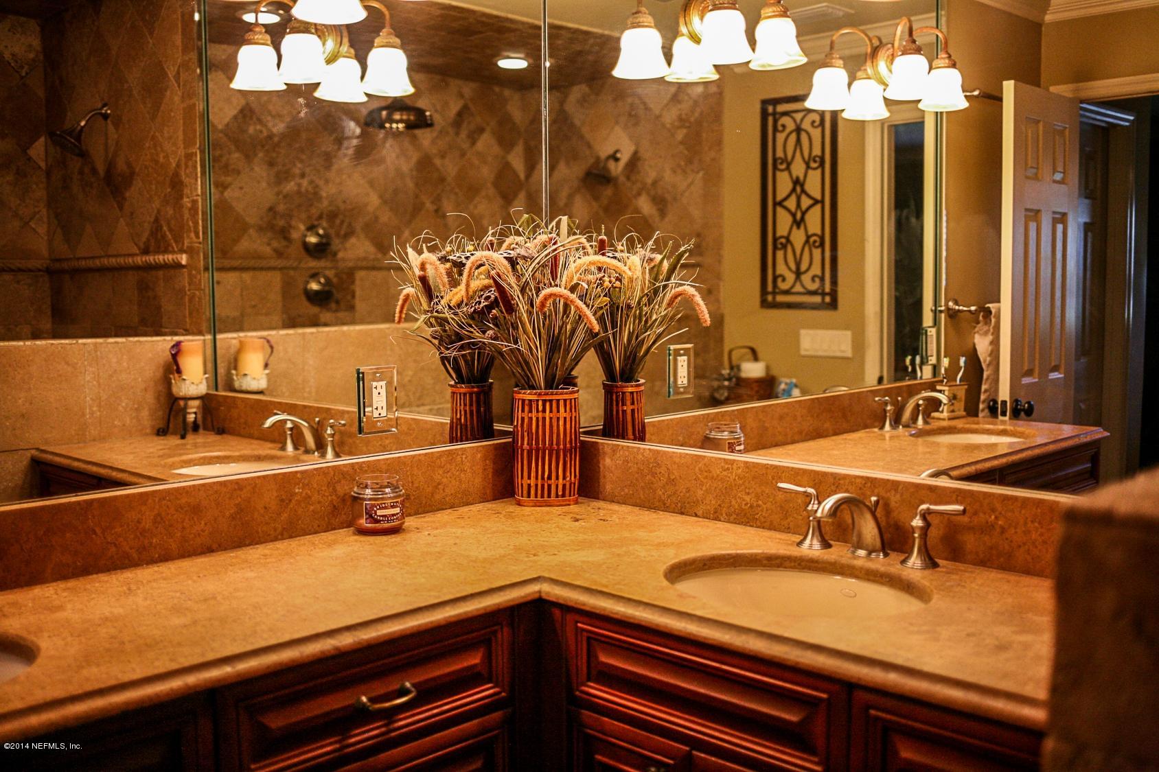 3967 Eunice Road Jacksonville, FL 32250 - Photo 16 of 28 a bathroom with a sink and a mirror