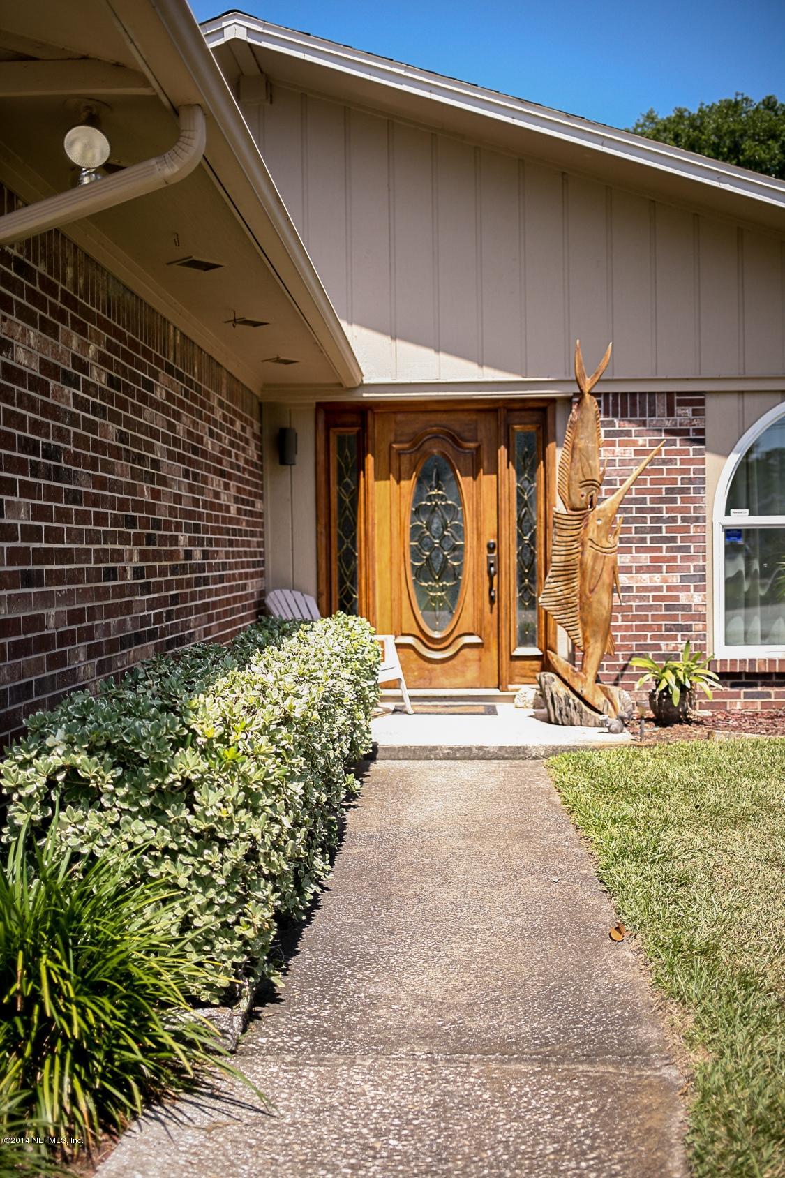 3967 Eunice Road Jacksonville, FL 32250 - Photo 2 of 28 a front view of a building with garden