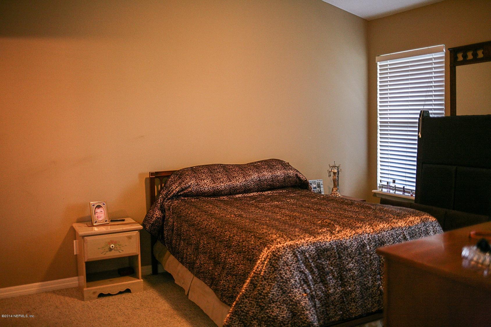 3967 Eunice Road Jacksonville, FL 32250 - Photo 26 of 28 a bedroom with a bed and a window