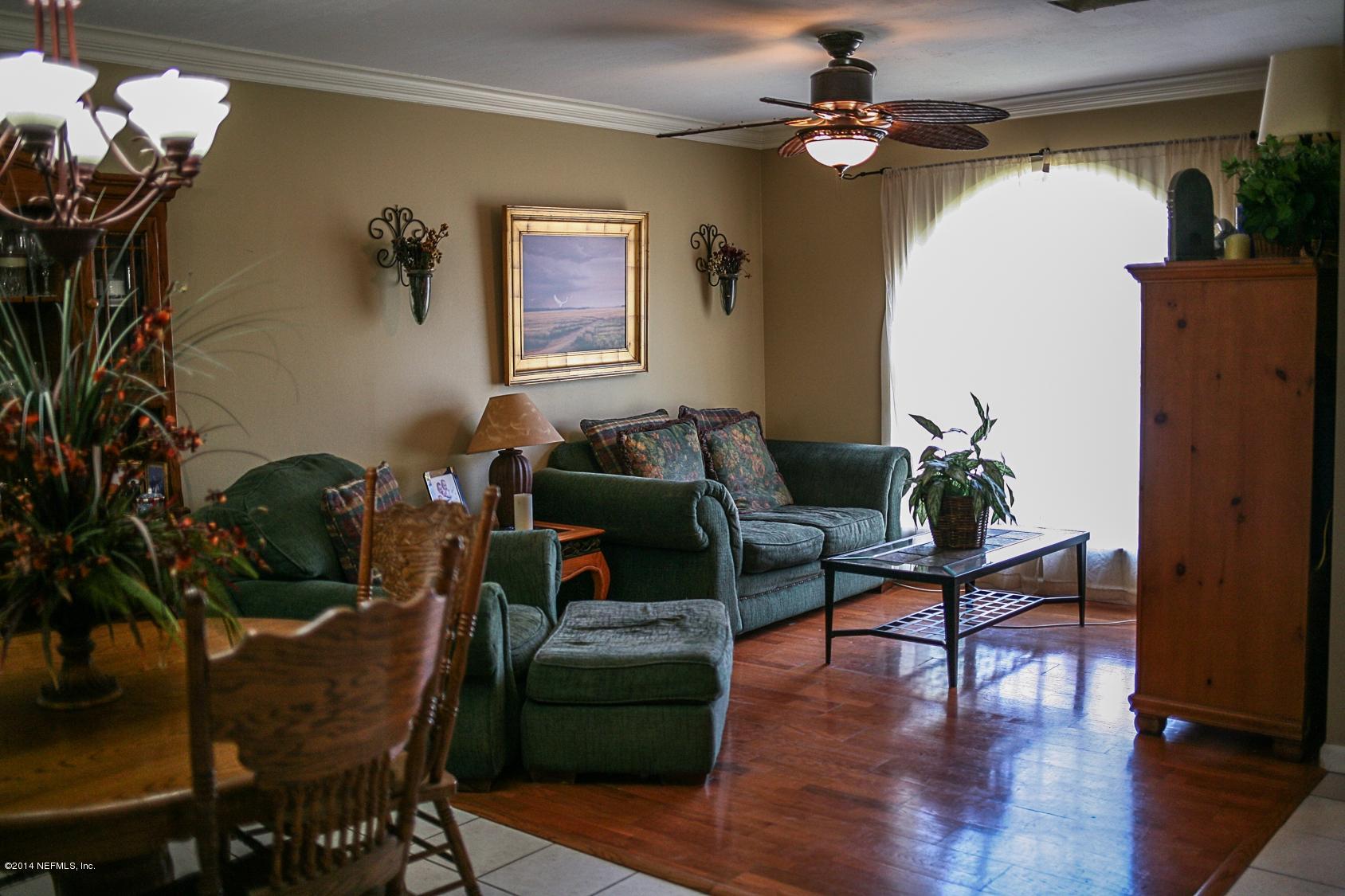 3967 Eunice Road Jacksonville, FL 32250 - Photo 4 of 28 a living room with furniture dining table and a potted plant