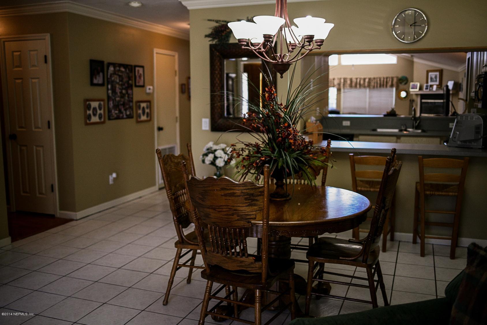 3967 Eunice Road Jacksonville, FL 32250 - Photo 6 of 28 a dining room with furniture and chandelier